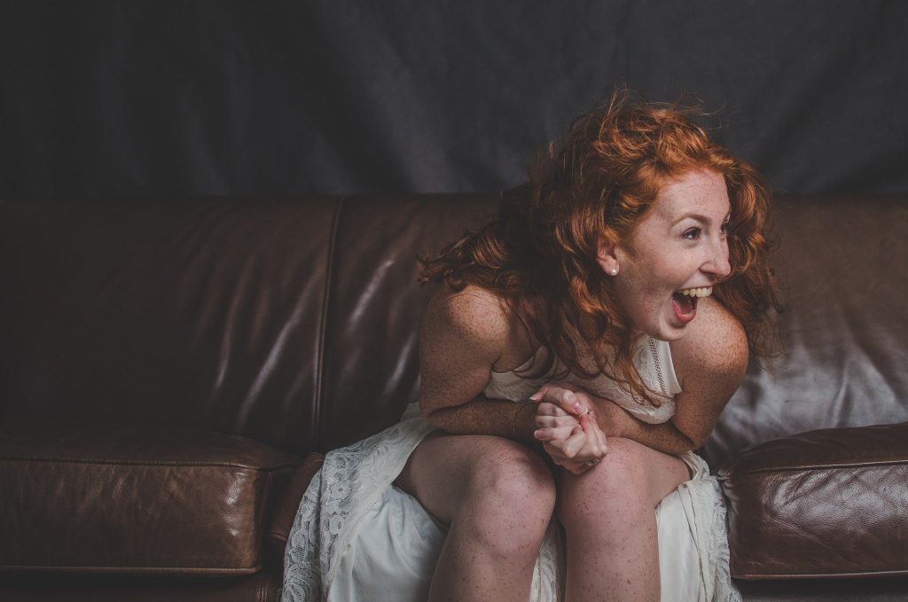 a woman smiling in the sofa