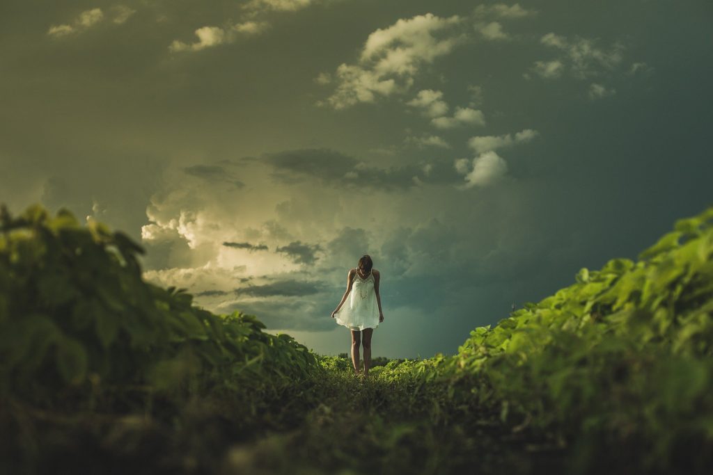 woman standing in the green field