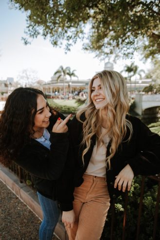 two women laughing with each other 