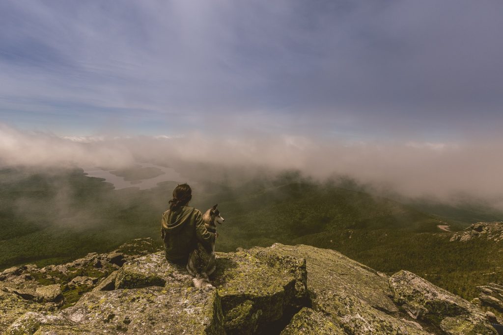 woman with her dog in the mountain