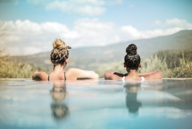 two women swimming on a pool