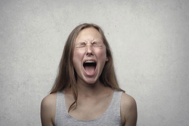 woman shouting with her eyes close