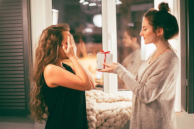 woman surprising a gift to someone 