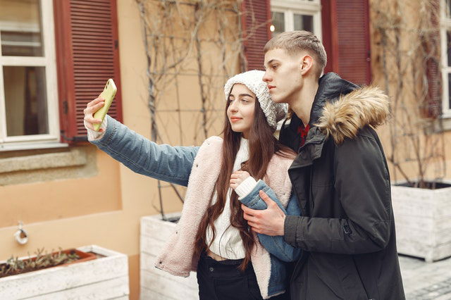 man and woman taking selfie 