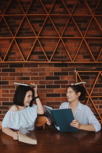 two women playing with books