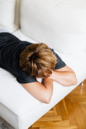 woman in black t-shirt lying on bed