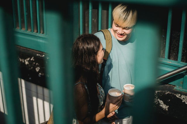 couple going upstairs with drinks in their hands