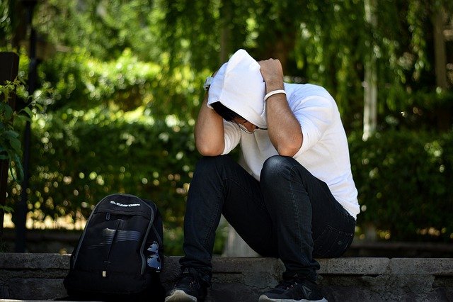 upset man wearing a white hoodie