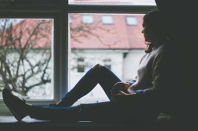 woman sitting near the window