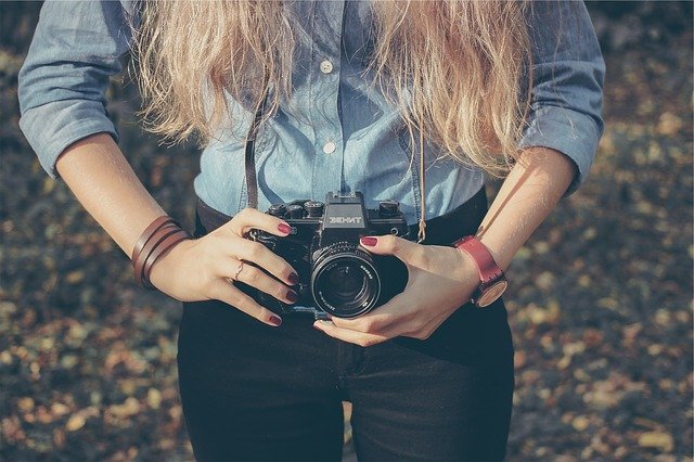 woman taking picture using a camera