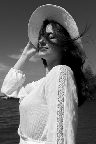 happy woman with eyes close in a hat