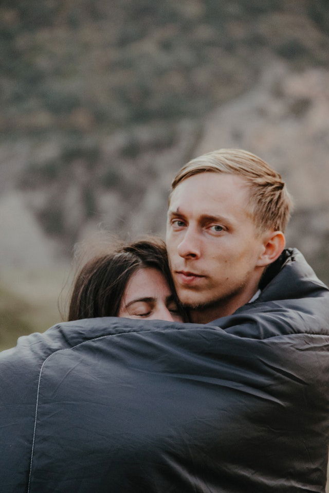 man hugging woman 