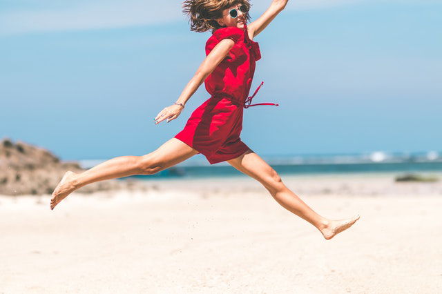 woman in red jumping 