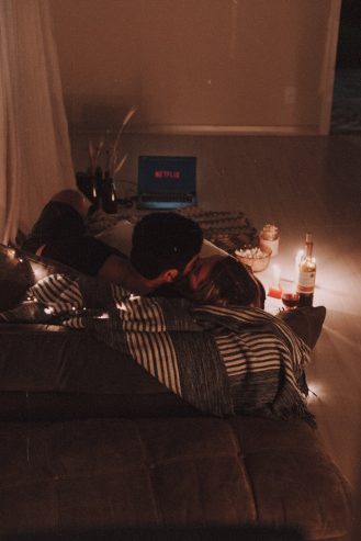 couple kissing on couch 