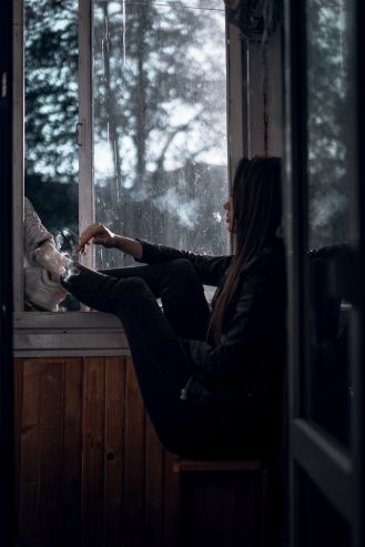 women sitting near window
