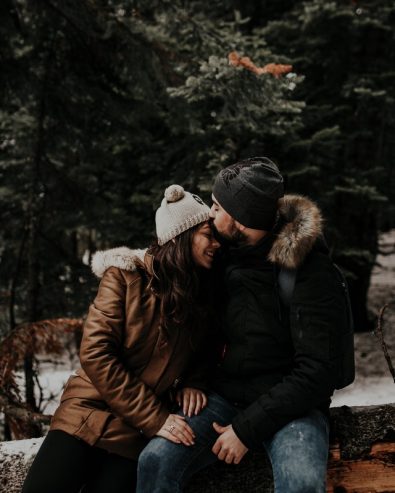 man kissing woman's forehead 
