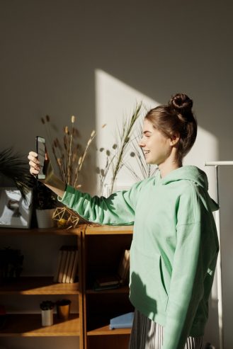 girl taking a photo using a smartphone 