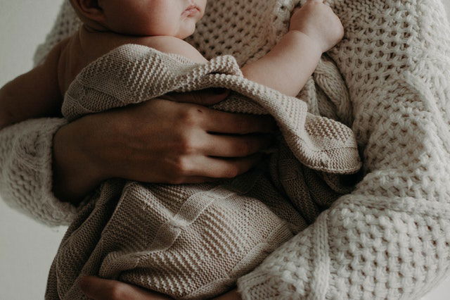 woman carrying a baby 