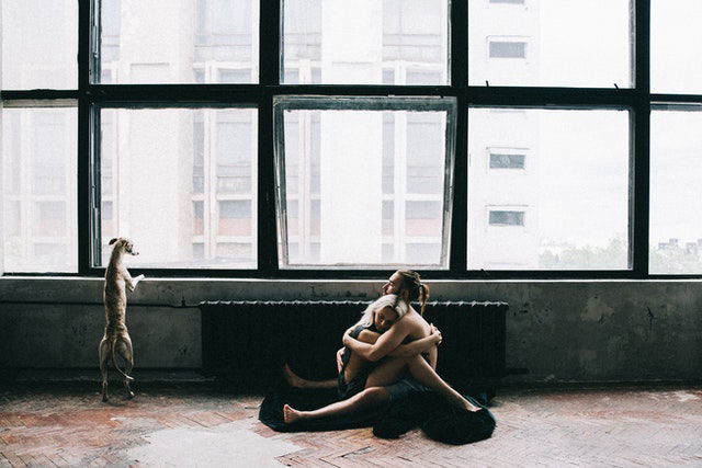 couple sitting and hugging on the floor 