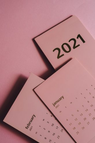 paper calendars with months on pink background 