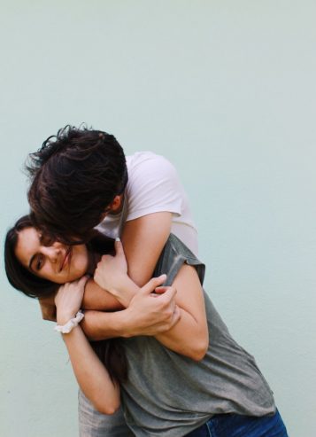 man hugs and kisses a woman 