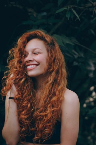 smiling woman with red hair 