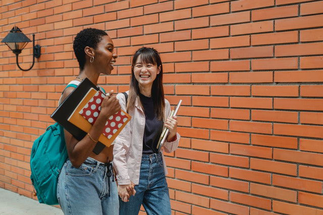 multiracial students talking after class