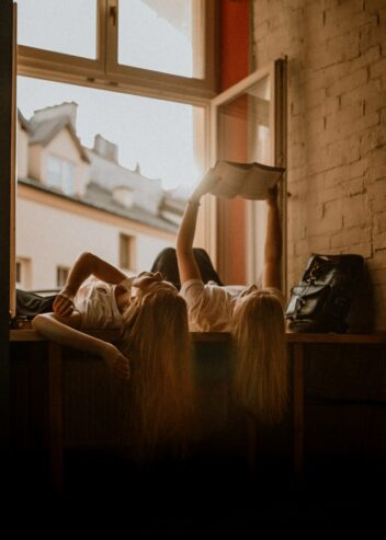 women reading a book while lying down 