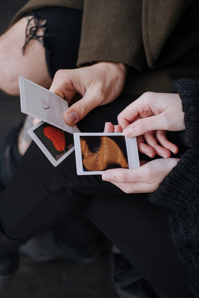 faceless couple holding a handmade Valentine's Day cards