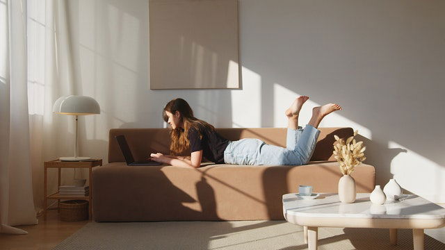 woman watching an online concert using her laptop