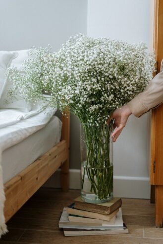person holding white flower bouquet